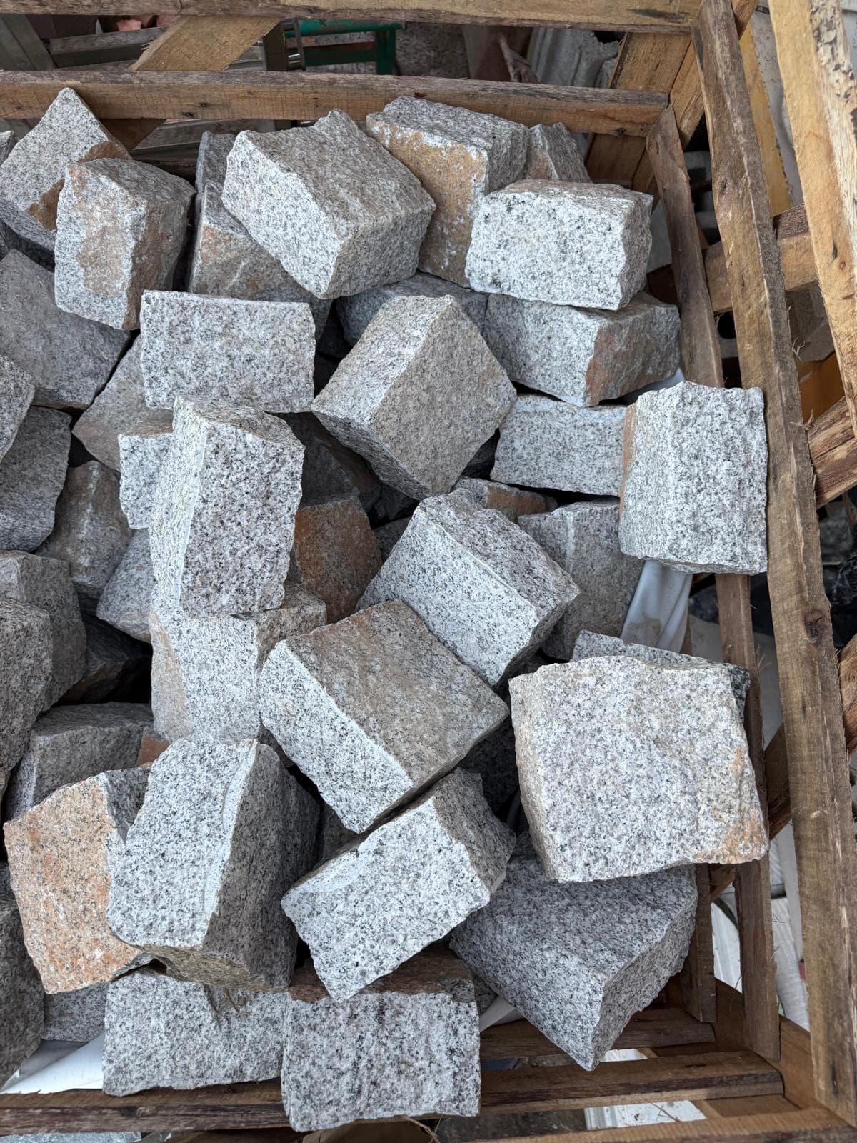 Stack of natural granite cobblestone in our yard